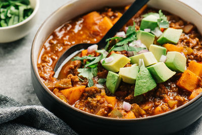 Paleo chili con carne closeup with fresh cilantro and avocado