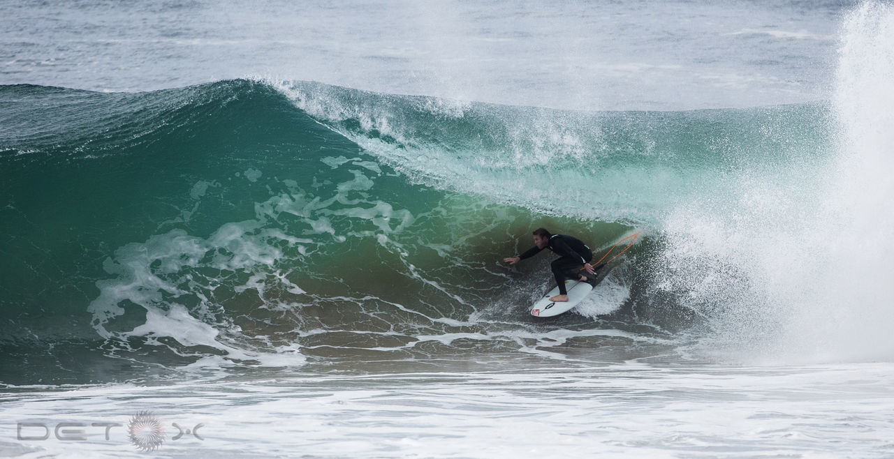 MAN SURFING ON SEA