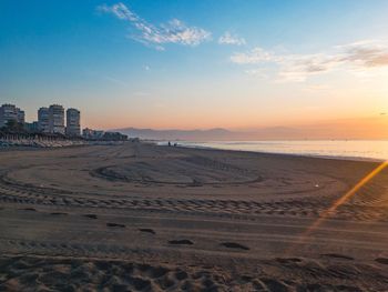 Scenic view of beach against sky during sunset