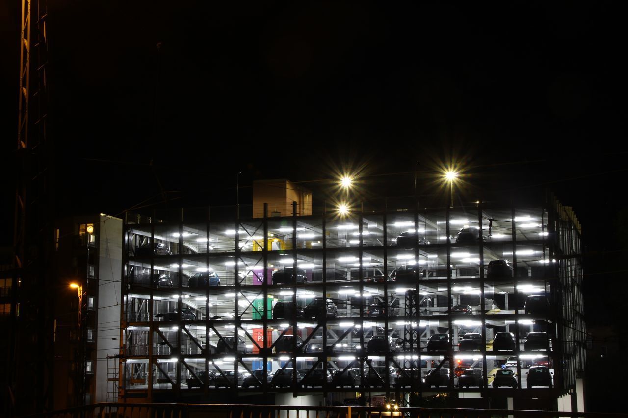 LOW ANGLE VIEW OF ILLUMINATED STREET LIGHTS IN CITY