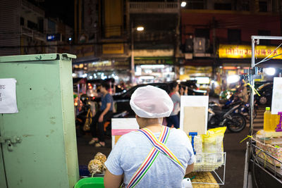 Rear view of woman working at market