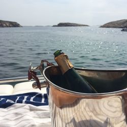 Champagne bottle in ice bucket on boat