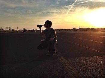 Silhouette of woman at sunset