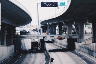 Semi-truck below bridge on highway