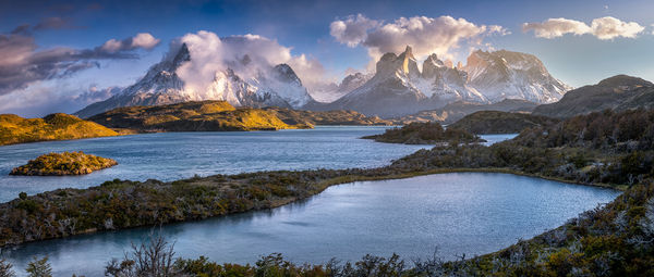 Scenic view of lake and mountains against sky