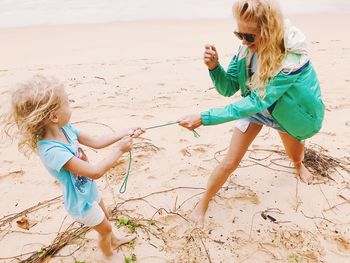 Mother and daughter enjoying at beach