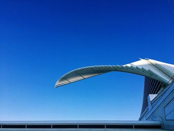 Low angle view of modern building against clear blue sky