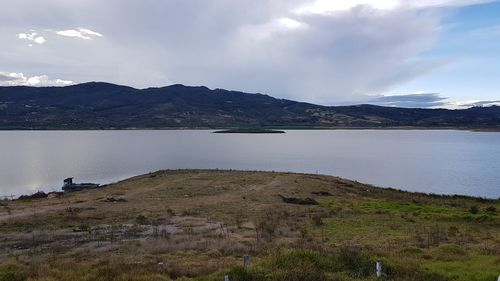 Scenic view of lake and mountains against sky