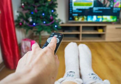 Low section of woman using mobile phone