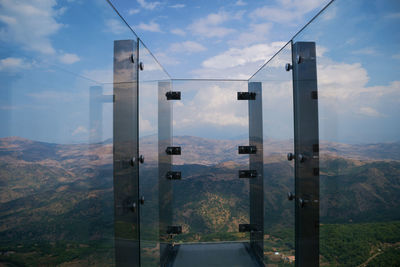 Scenic view of mountains and buildings against sky