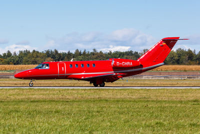 Red airplane on field