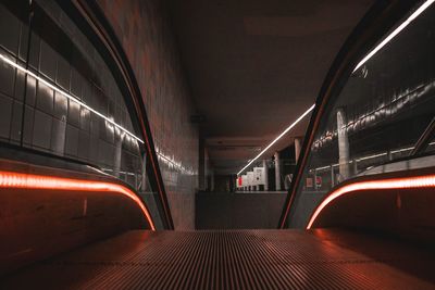 Train at illuminated railroad station at night