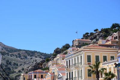 Residential buildings against clear blue sky