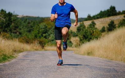 Full length of man running on road