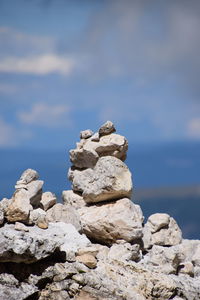 Close-up of rocks in sea against sky