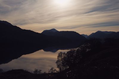 Scenic view of silhouette mountains against sky during sunset