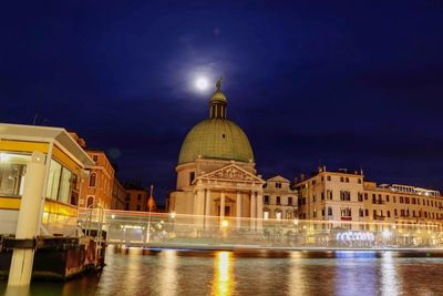 Illuminated building against sky at night