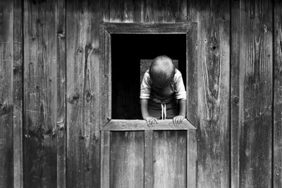 Rear view of man on wooden door