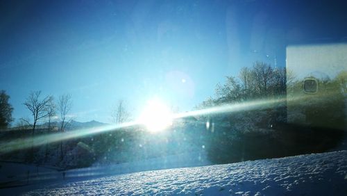 Scenic view of landscape against sky during winter