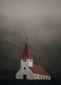 Church on mountain during foggy weather