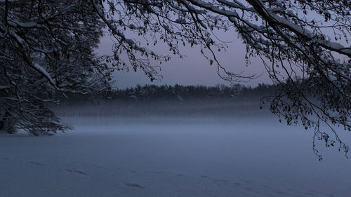 Scenic view of landscape against sky during winter