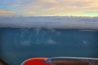 Close-up of airplane wing against sky