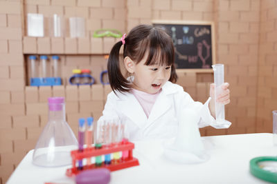 Young girl play science experiments for homeschooling