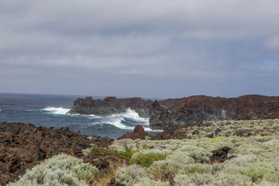 Scenic view of sea against cloudy sky