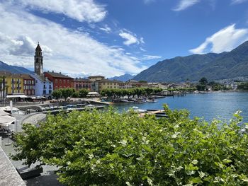 Scenic view of buildings by mountains against sky