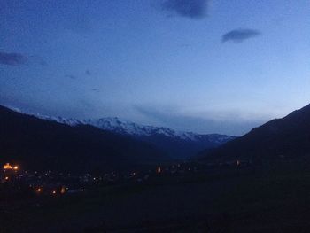 Scenic view of mountains against cloudy sky