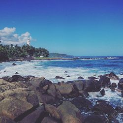 Scenic view of sea against blue sky