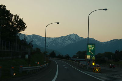 Road by mountain against sky