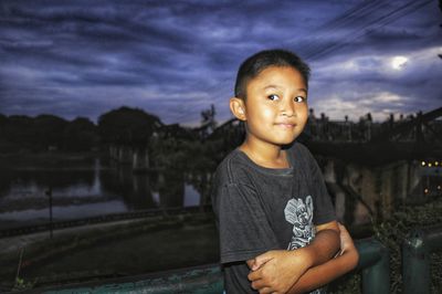 Portrait of cute boy against sky