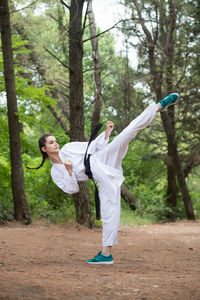 Full length of young woman playing in park