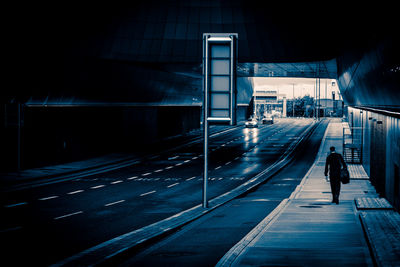 Man walking on sidewalk in city