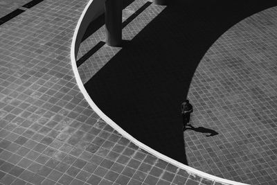 Low section of person walking on tiled floor