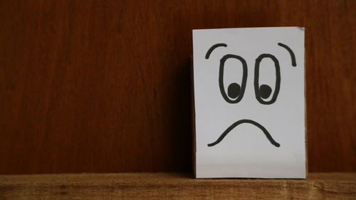 Close-up of text on wooden table