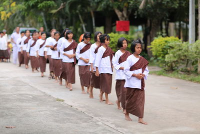 Group of people walking on footpath