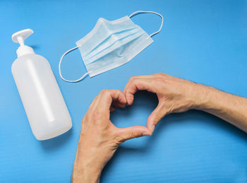 High angle view of man holding hands over white background