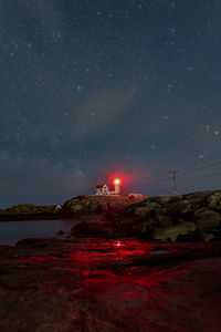 Nubble lighthouse against starry sky at night