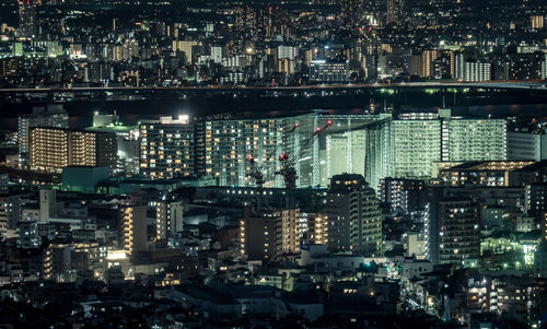 Aerial view of illuminated buildings in city at night