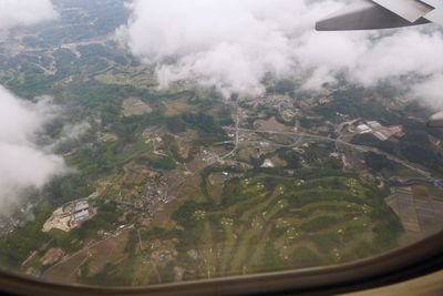 Aerial view of airplane wing over landscape