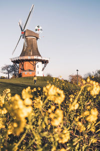 Traditional windmill on field against sky