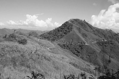 Scenic view of mountains against cloudy sky