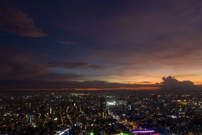 High angle view of illuminated city buildings at night