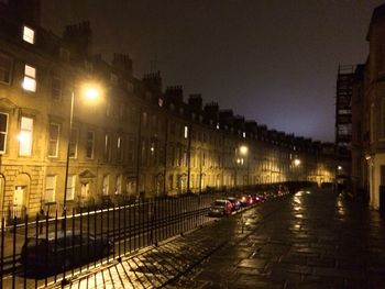 Illuminated street lights in city at night