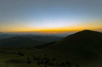 Scenic view of silhouette mountains against clear sky