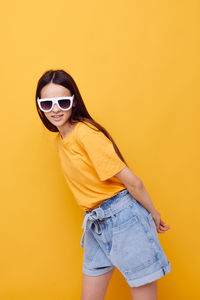 Teenager girl against yellow background
