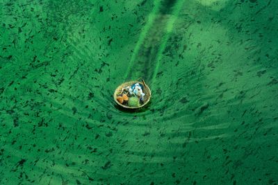 High angle view of people sitting in basket boat