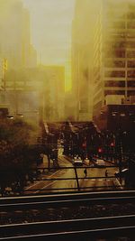 Railroad tracks by buildings in city against sky